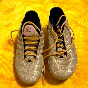 Beautiful gold Nike sneakers.